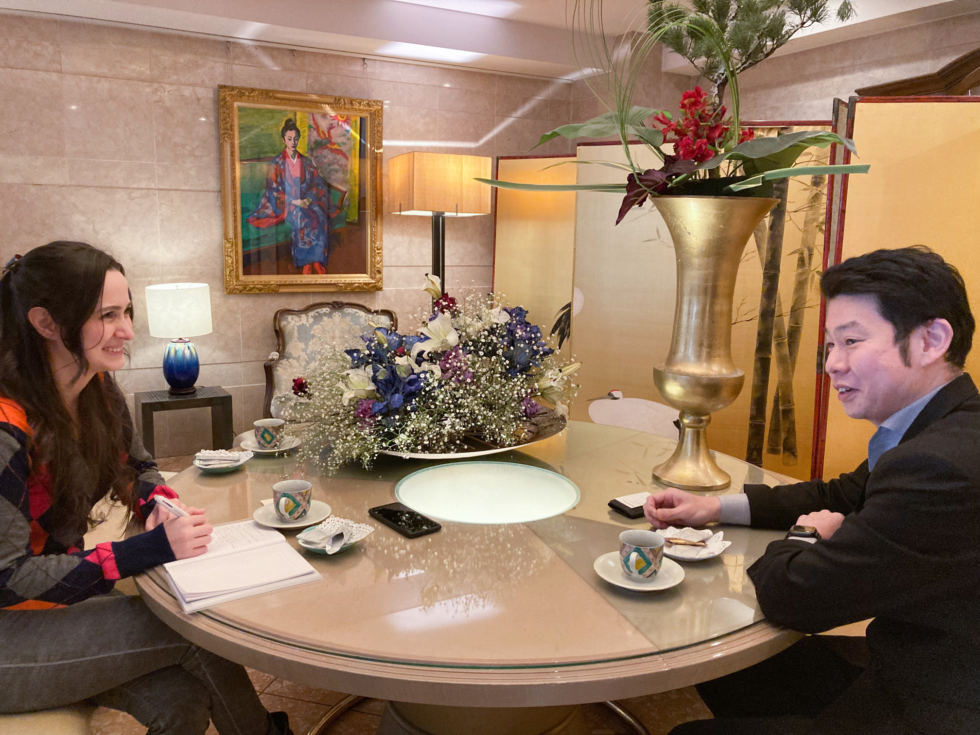 Masuda-san and I, a painting done by a Ryukyu artist hanging in the background