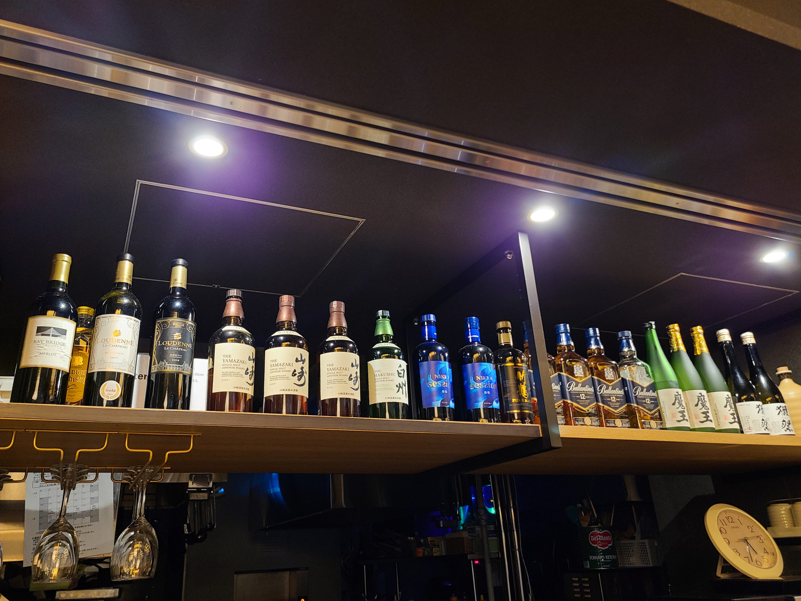 The bar counter at the restaurant, its shelf lined with various whiskies