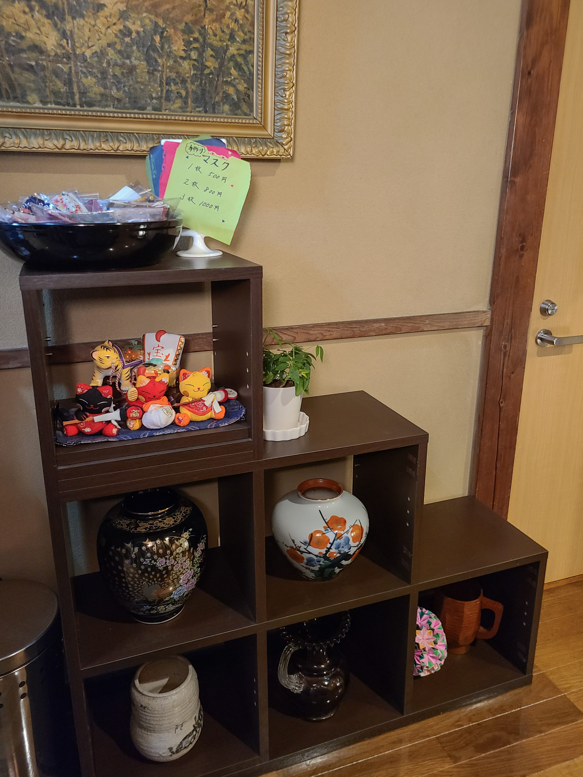 A large fan hangs in the staircase, and small antiques decorate the hall