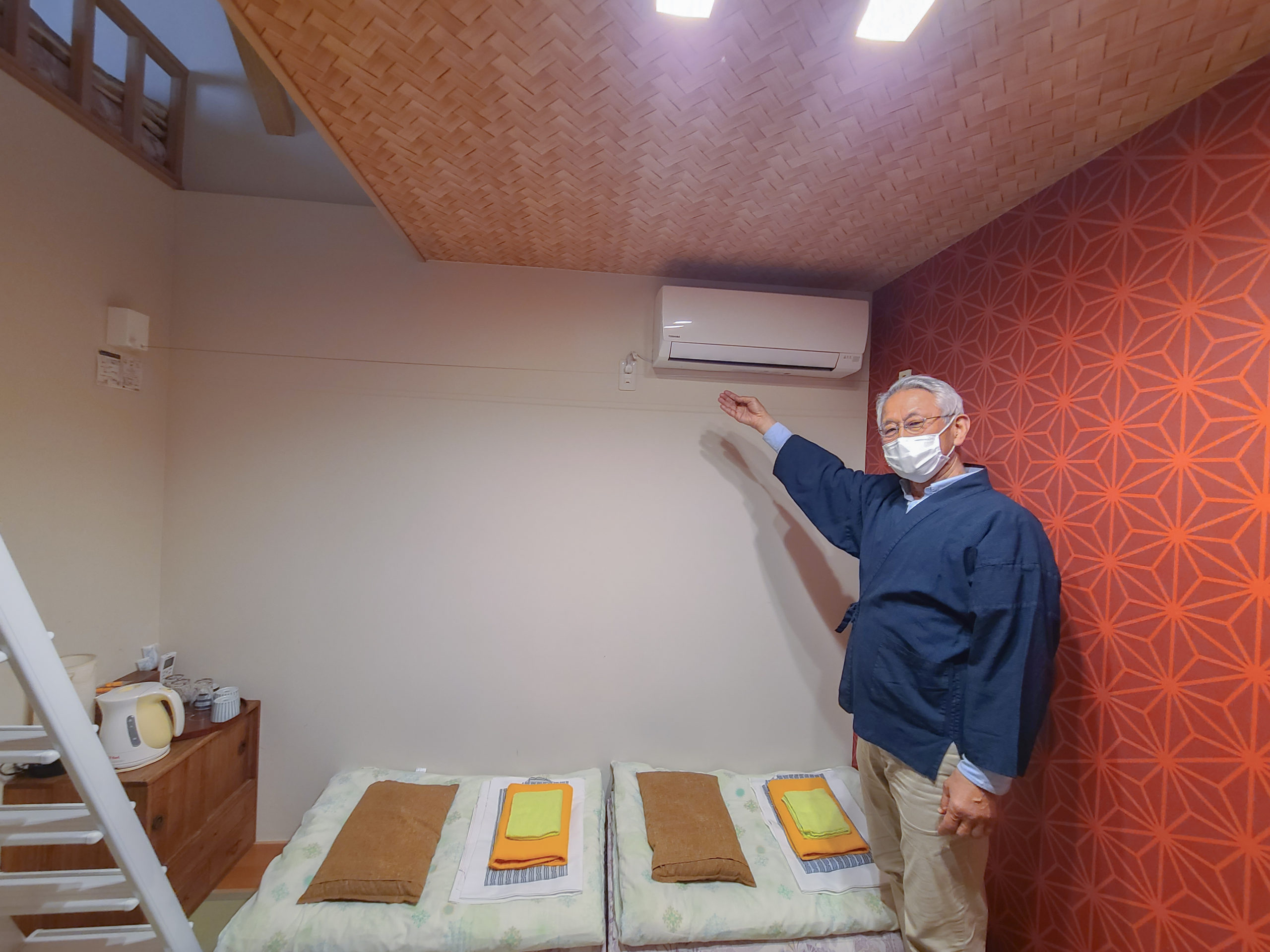 Furuichi-san motions to the indoor clothesline