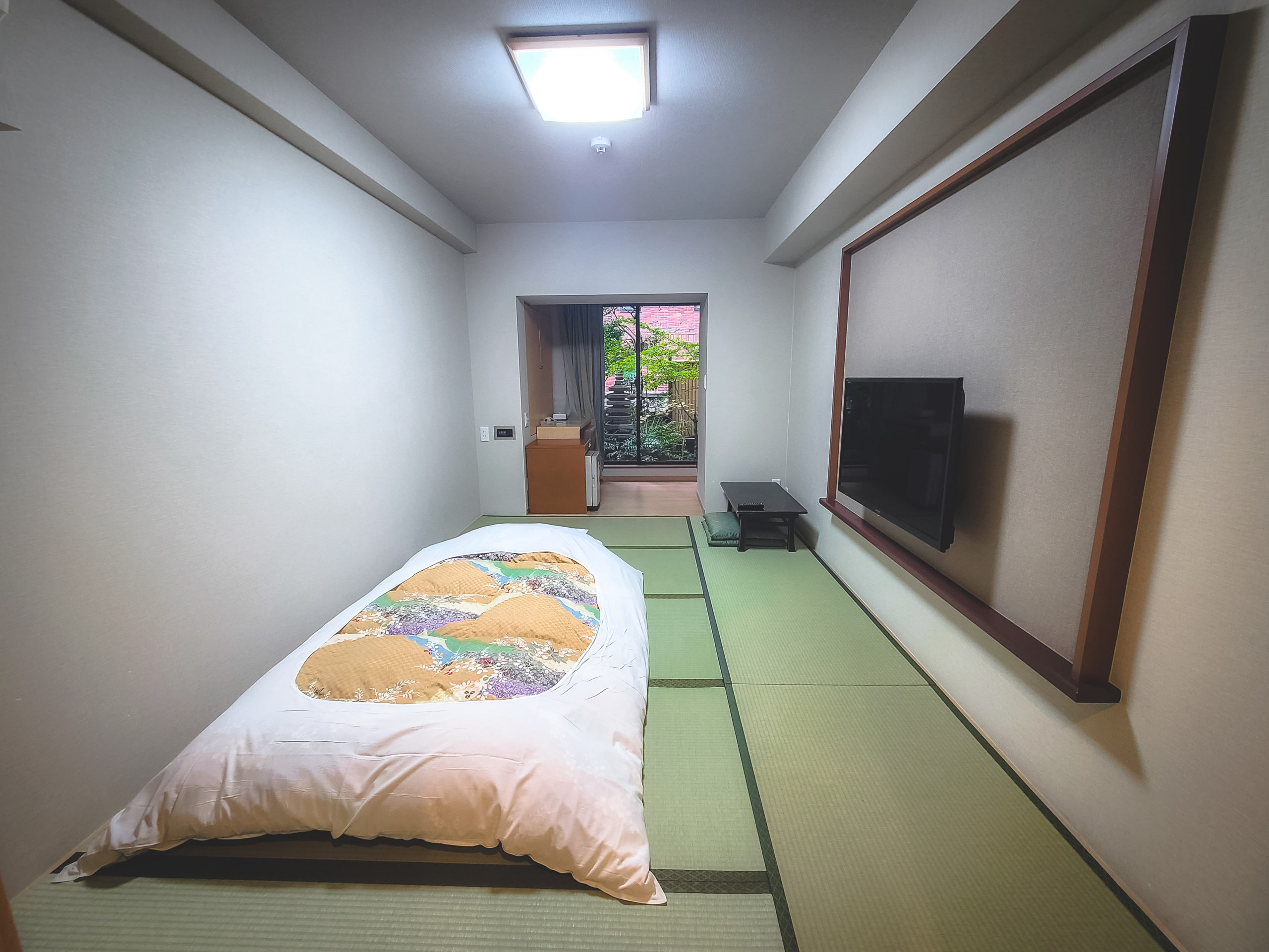 This washitsu looks out into a small garden situated on the roof of the floor below it